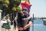 A crew member assigned to the Coast Guard Cutter Bertholf (WMSL 750) greets his family at the cutter's return to home port on Coast Guard Base Alameda, Calif., following a 98-day patrol in the Indo-Pacific region, April 8, 2024. Throughout the deployment, Bertholf led international engagements in The Republic of Singapore, Malaysia, and India, strengthening interoperability and maritime governance through joint at-sea exercises, professional engagements, and subject matter expert exchanges. (U.S. Coast Guard Photo by Petty Officer 3rd Class Hunter Schnabel)