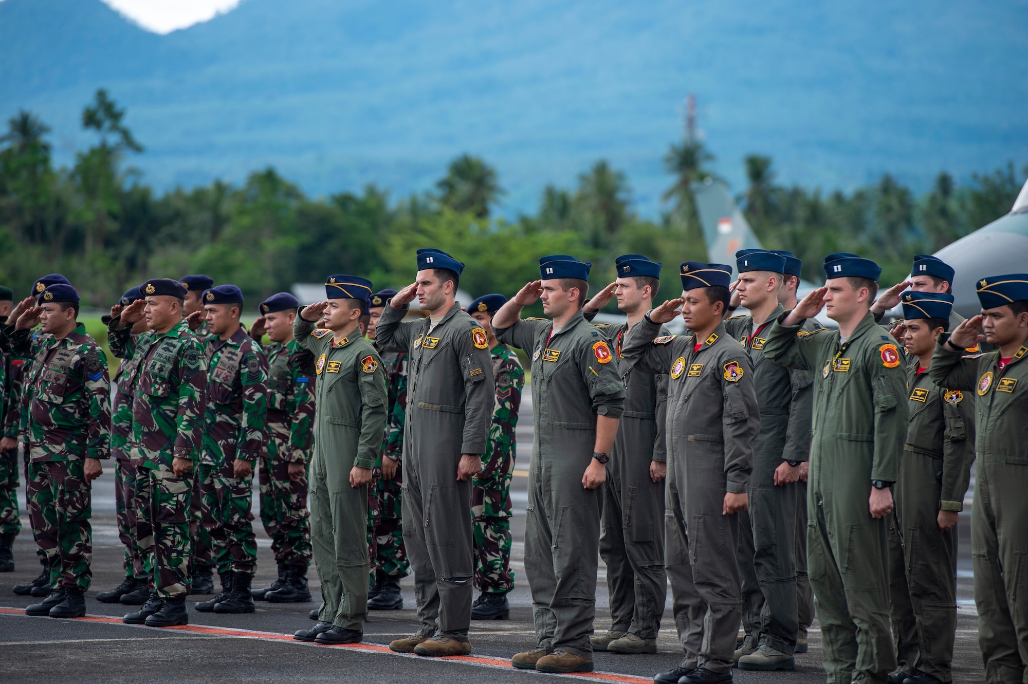 A group of Airmen salute.