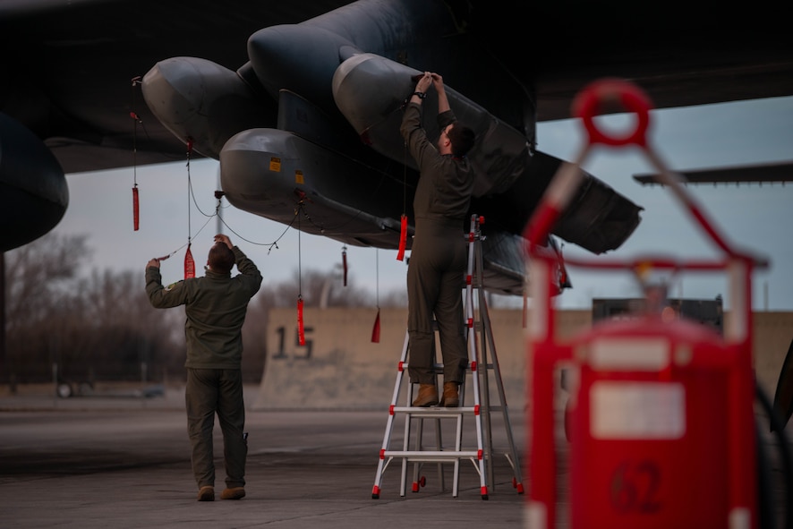 Minot Airmen perform maintenance on a B-52H Stratofortress assigned to the 23rd Bomb Squadron during Exercise Prairie Vigilance/Bayou Vigilance 24-3 at Minot Air Force Base, North Dakota, April 7, 2024. Exercises like this continually develop Airmen and Aircrew skill sets by improving operational capabilities and increasing mission readiness. (U.S. Air Force photo by Airman 1st Class Luis Gomez)