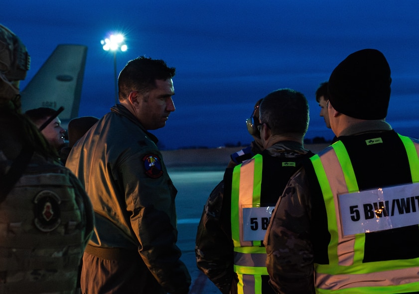 U.S. Air Force Lt. Col. Ryan Loucks, commander of the 23rd Bomb Squadron, speaks with Airmen on the flight line during Exercise Prairie Vigilance/Bayou Vigilance 24-3 at Minot Air Force Base, North Dakota, April 7, 2024. These exercises ensure the always-ready, global strike capability and enable crews to maintain a high state of readiness and proficiency. (U.S. Air Force photo by Airman 1st Class Alyssa Bankston)