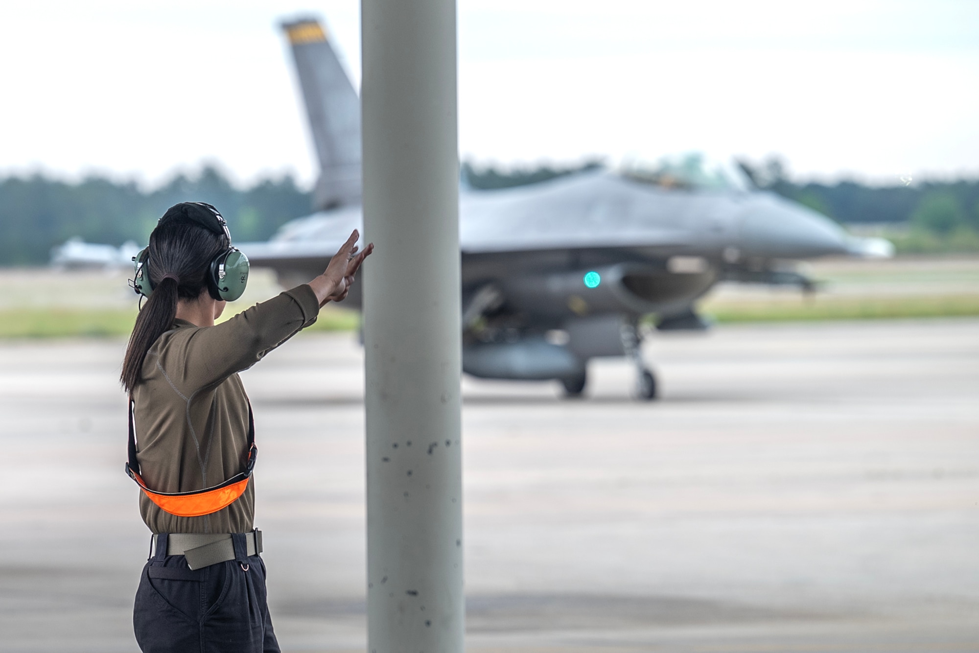 A1C Kindle, 79th FGS, guides Lt. Gen. Grynkewich, 9th AF (AFCENT) commander, to his parking spot as he completes his final flight as AFCENT commander.