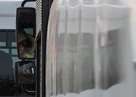An Airman assigned to the 5th Logistics Readiness Squadron checks his side-view mirror during Prairie Vigilance 24-3 at Minot Air Force Base, North Dakota, April 8, 2024. Exercises such as Prairie Vigilance ensure Airmen stay proficient in a variety of key operational skills. (U.S. Air Force photo by Airman 1st Class Kyle Wilson)
