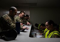 Minot Airmen simulate pre-deployment personnel processing during Prairie Vigilance 24-3 at Minot Air Force Base, North Dakota, April 9, 2024. Exercises like Prairie Vigilance continually develop Airmen and aircrew skill sets by improving operational capabilities and increasing mission readiness. (U.S. Air Force photo by Airman 1st Class Kyle Wilson)