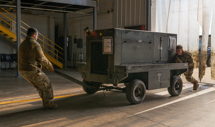 Airmen assigned to the 5th Logistics Readiness Squadron move equipment during Prairie Vigilance 24-3 at Minot Air Force Base, North Dakota, April 9, 2024. Exercises such as Prairie Vigilance ensure Airmen stay proficient in a variety of key operational skills. (U.S. Air Force photo by Airman 1st Class Kyle Wilson)