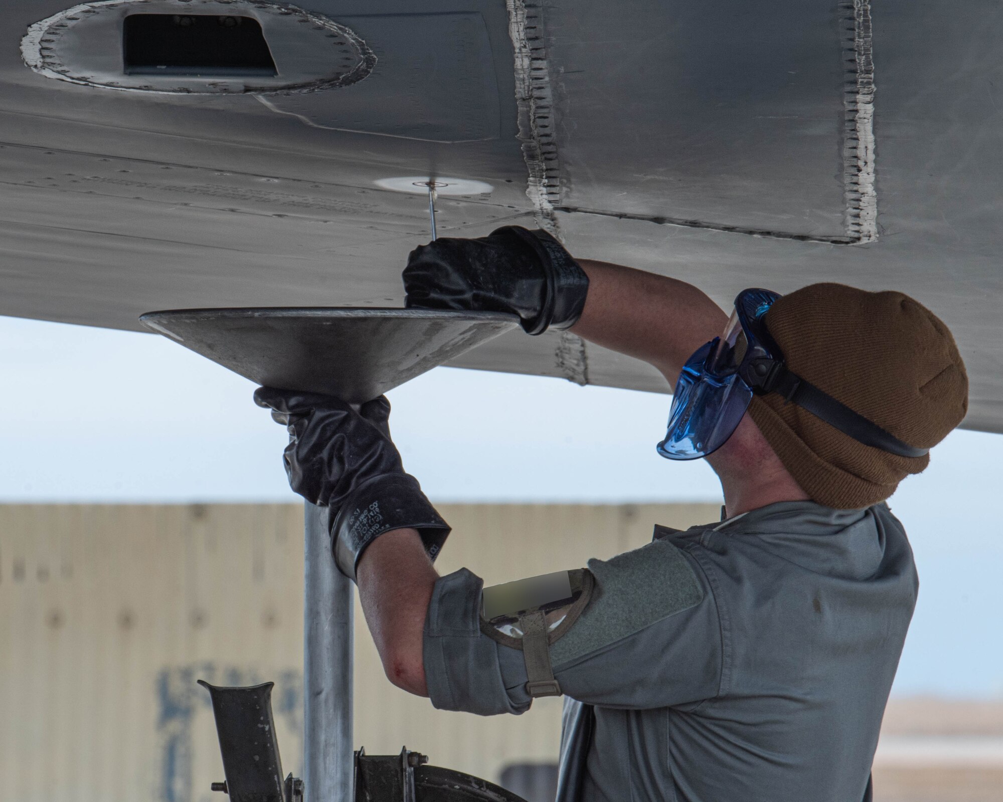 An Airman assigned to the 5th Logistics Readiness Squadron drains fuel from a B-52H Stratofortress during Prairie Vigilance 24-3 at Minot Air Force Base, North Dakota, April 7, 2024. Prairie Vigilance demonstrates the capability, resilience, adaptability, and strength of Team Minot Airmen. (U.S. Air Force photo by Airman 1st Class Kyle Wilson)