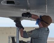 An Airman assigned to the 5th Logistics Readiness Squadron drains fuel from a B-52H Stratofortress during Prairie Vigilance 24-3 at Minot Air Force Base, North Dakota, April 7, 2024. Prairie Vigilance demonstrates the capability, resilience, adaptability, and strength of Team Minot Airmen. (U.S. Air Force photo by Airman 1st Class Kyle Wilson)