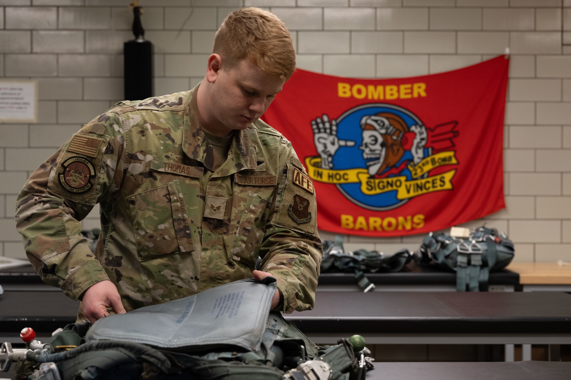 Senior Airman Hunter Thomas, 5th Operations Support Squadron aircrew flight equipment journeyman, assembles a pilot ejection harness during Prairie Vigilance 24-3 at Minot Air Force Base, North Dakota, April 8, 2024. Prairie Vigilance serves to ensure Allies and partners that the U.S. is ready to execute nuclear options and global strike anytime, anywhere, in order to deter and, if necessary, respond to strategic attack. (U.S. Air Force photo by Airman 1st Class Trust Tate)