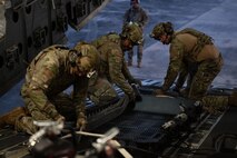 People pack a fuel hose.