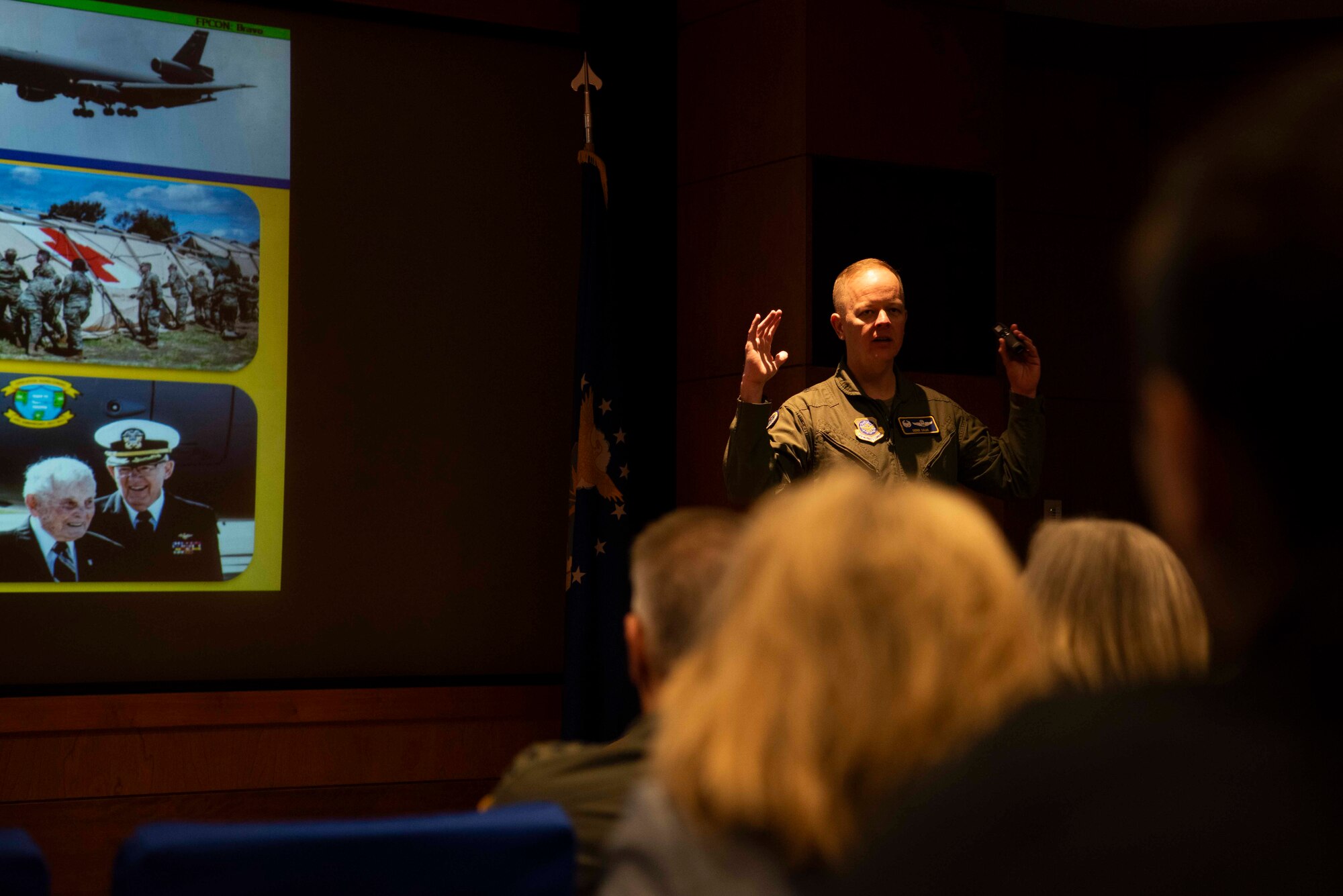 An Airman briefs a large group of people