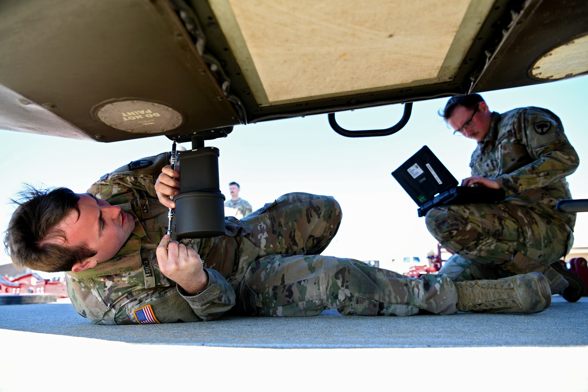U.S. Army Spcs. David Leitner, right, and Matthew Dayton, left, 1-151st Attack Reconnaissance Battalion, South Carolina Army National Guard AH-64 Apache helicopter Armament/Electrical/Avionics Systems Repairers, prepare an AH-64E Apache Guardian for loading onto a U.S. Air Force C-5M Super Galaxy at Shaw Air Force Base, S.C., March 21, 2024. This was the first time a loading of this type took place at Shaw AFB. (U.S. Air Force photo by Staff Sgt. Kelsey Owen)