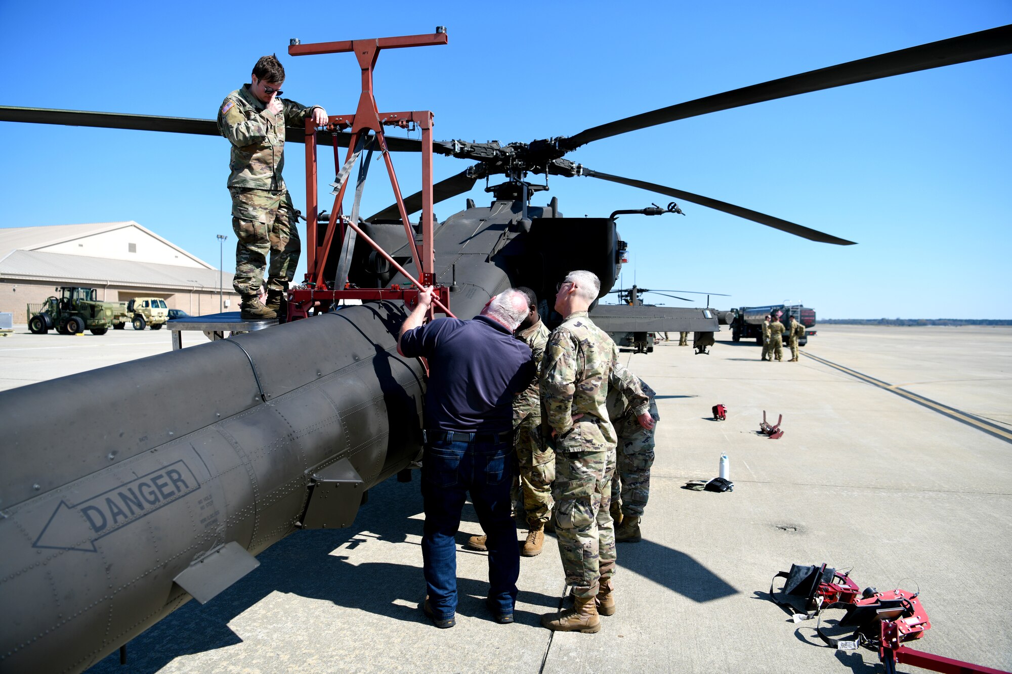 U.S. Soldiers assigned to the 1-151st Attack Reconnaissance Battalion, South Carolina Army National Guard, prepare an AH-64E Apache Guardian for loading onto a U.S. Air Force C-5M Super Galaxy at Shaw Air Force Base, S.C., March 21, 2024. Exercising these skills allows the Soldiers to execute the mission quickly and proficiently in a real-world scenario. (U.S. Air Force photo by Staff Sgt. Kelsey Owen)