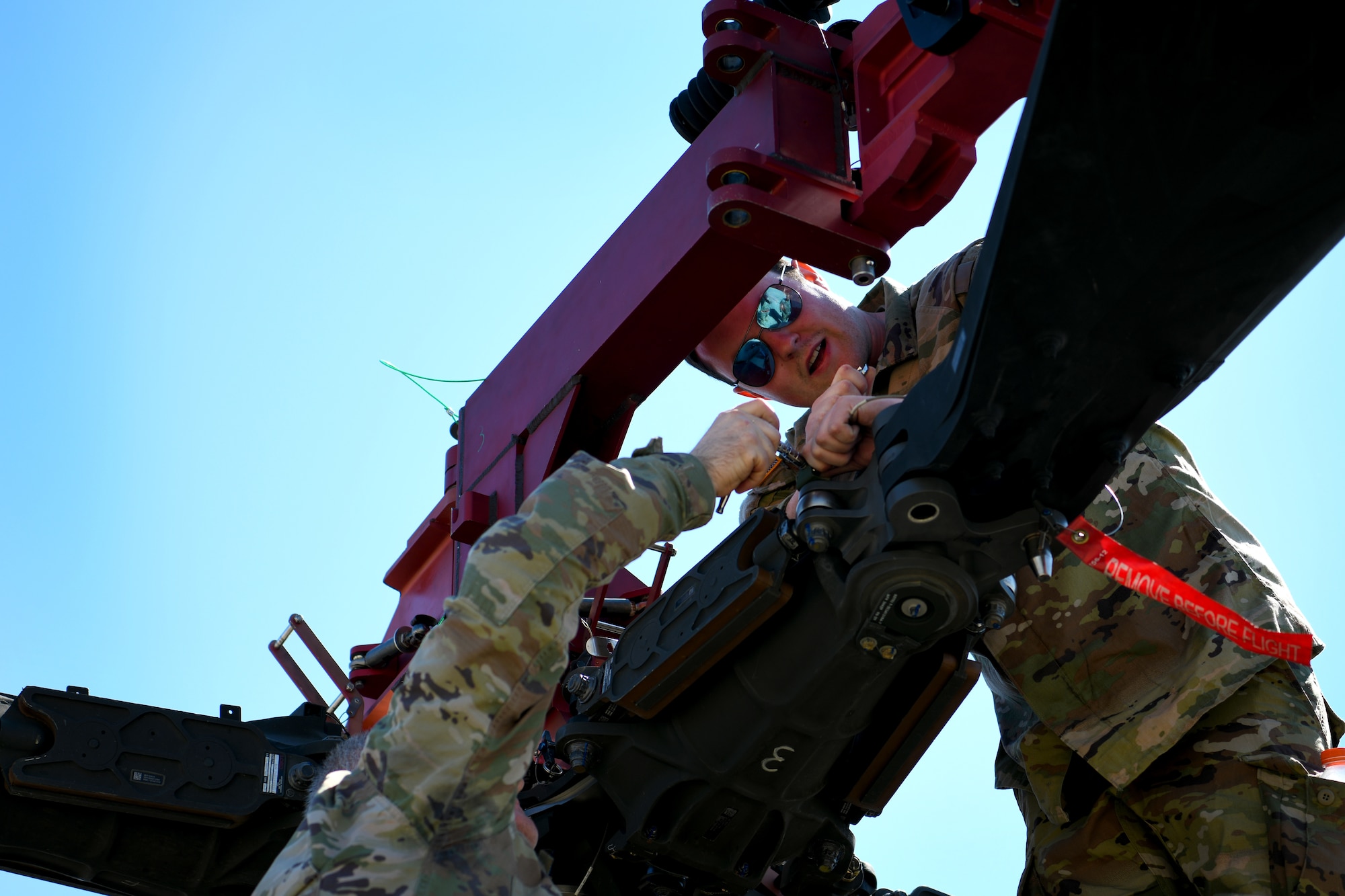 U.S. Army Sgt. Brice Becker, 1-151st Attack Reconnaissance Battalion, South Carolina Army National Guard AH-64E Apache Guardian helicopter crew chief, prepares an AH-64E for loading onto a U.S. Air Force C-5M Super Galaxy at Shaw Air Force Base, S.C., March 21, 2024. The two-day process marked the first time U.S. Army AH-64Es were loaded into a C-5M at Shaw AFB. (U.S. Air Force photo by Staff Sgt. Kelsey Owen)