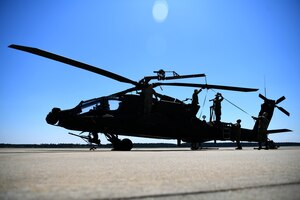 U.S. Soldiers assigned to the 1-151st Attack Reconnaissance Battalion, South Carolina Army National Guard, prepare an AH-64E Apache Guardian for loading onto a U.S. Air Force C-5M Super Galaxy at Shaw Air Force Base, S.C., March 21, 2024. The two-day process was an exercise in coordination and teamwork between the services. (U.S. Air Force photo by Staff Sgt. Kelsey Owen)