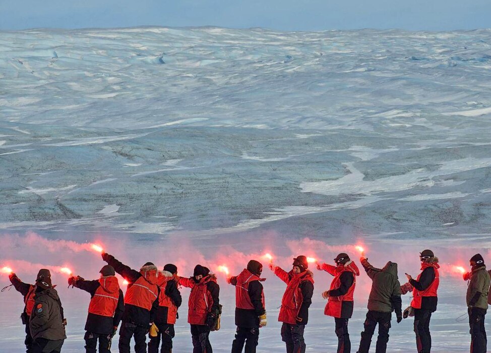 Royal Danish Air Force students hold flares during an Arctic survival training.