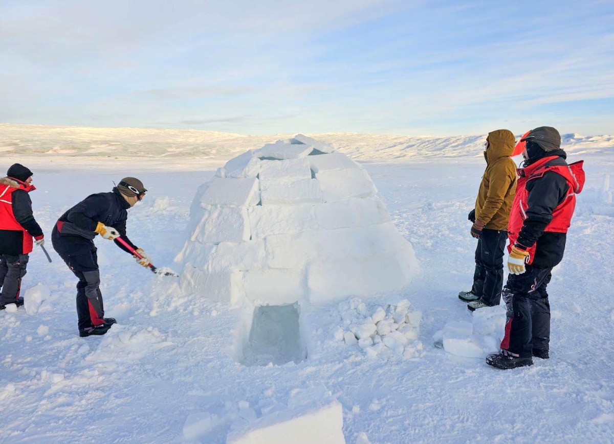 Royal Danish Air Force students stand next to their igloo in Kangerlussuaq, Greenland.