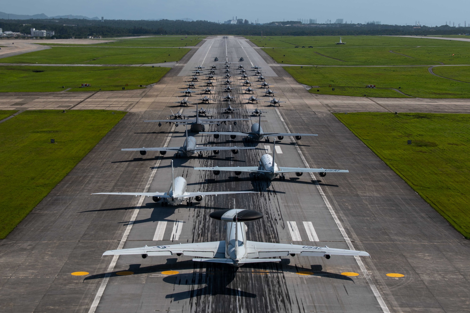 Many aircraft in formation on a runway
