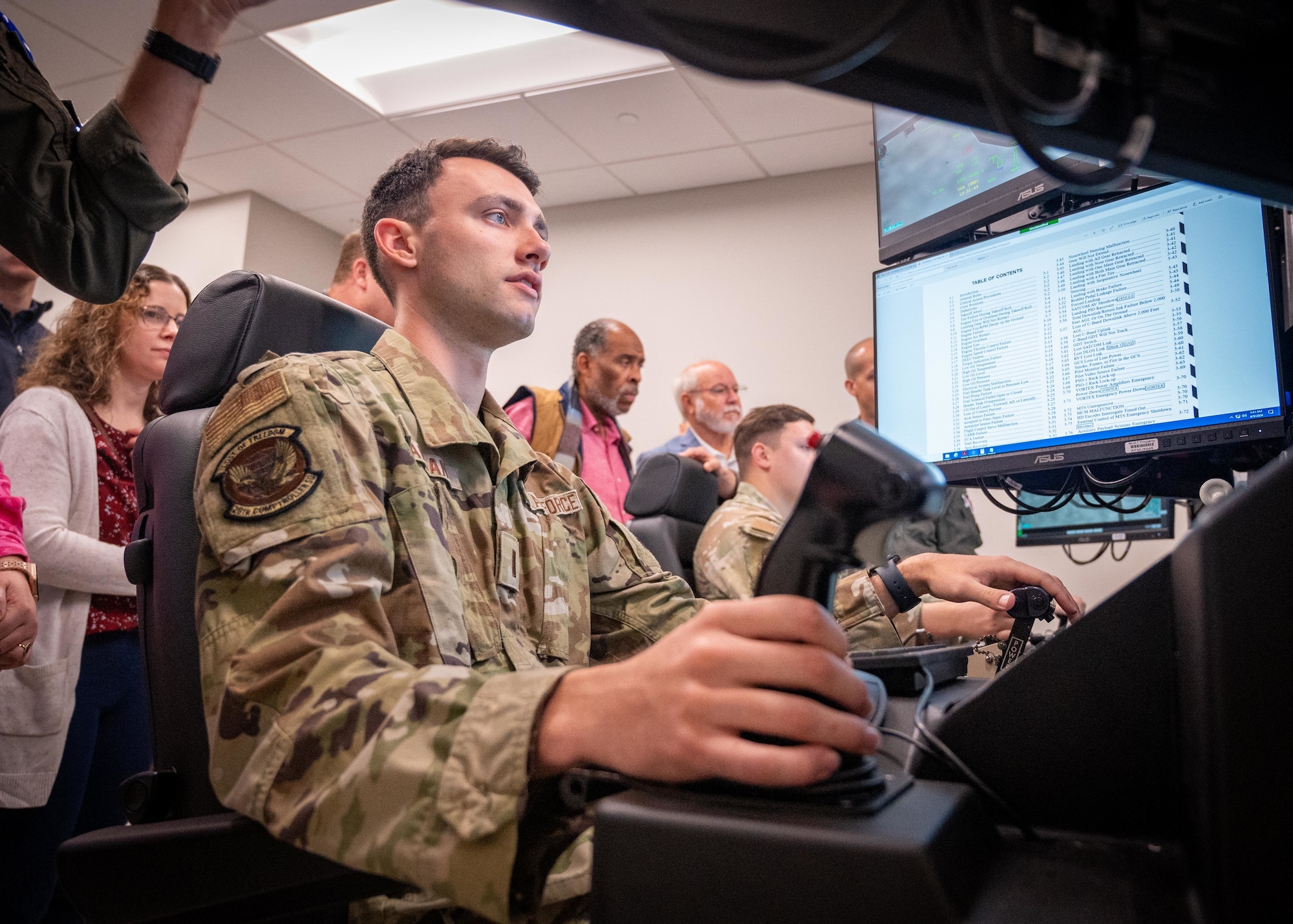 A lieutenant operates a remotely piloted aircraft simulator.