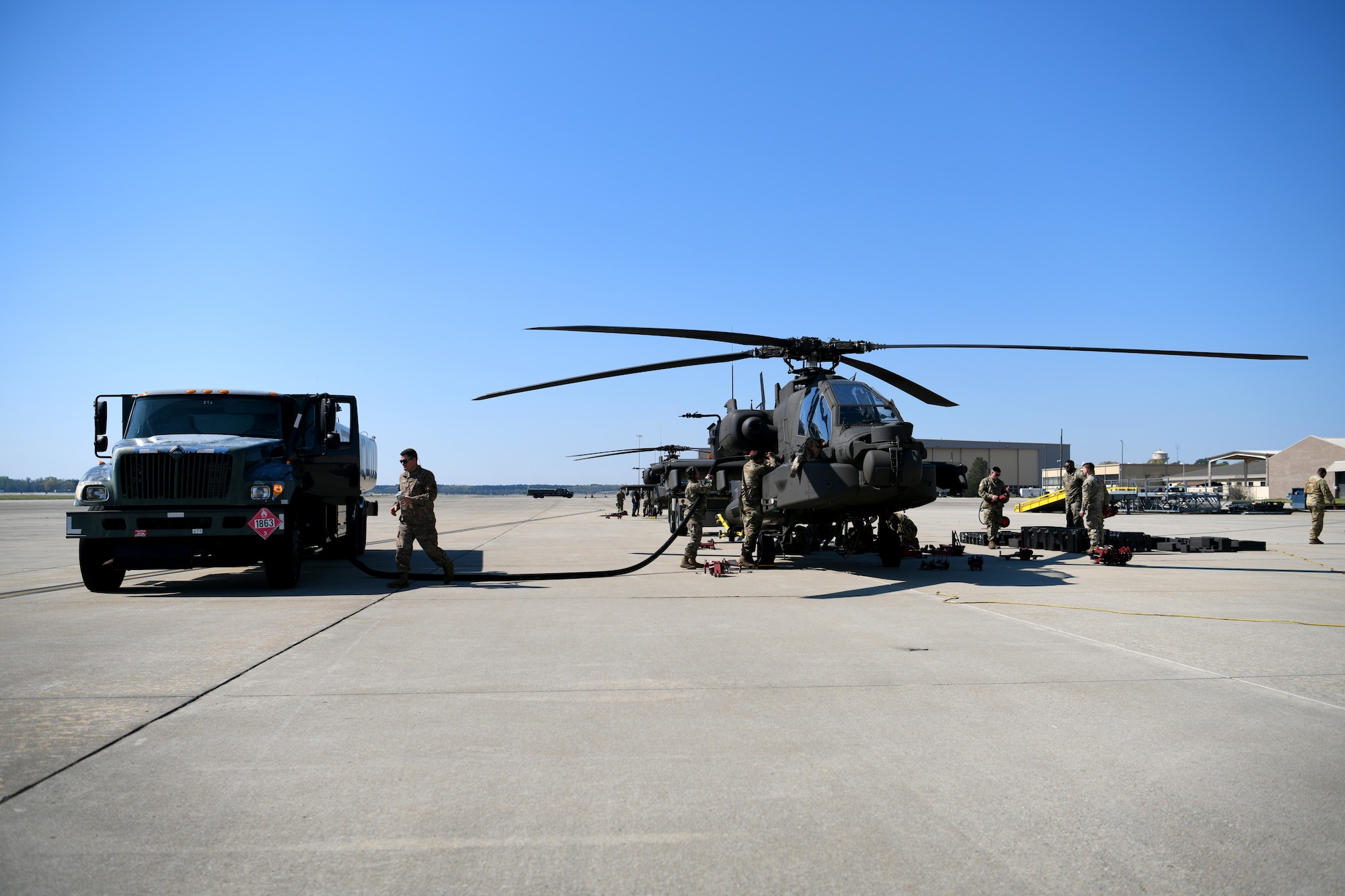 U.S. Airmen assigned to the 20th Logistics Readiness Squadron and U.S. Soldiers assigned to the 1-151st Attack Reconnaissance Battalion, South Carolina Army National Guard, defuel an AH-64E Apache Guardian helicopter at Shaw Air Force Base, S.C., March 21, 2024. Defueling the aircraft was the first step in preparing them for transfer via a C-5M Super Galaxy as part of a training exercise. (U.S. Air Force photo by Staff Sgt. Kelsey Owen)
