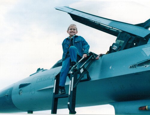 A child poses on a jet.