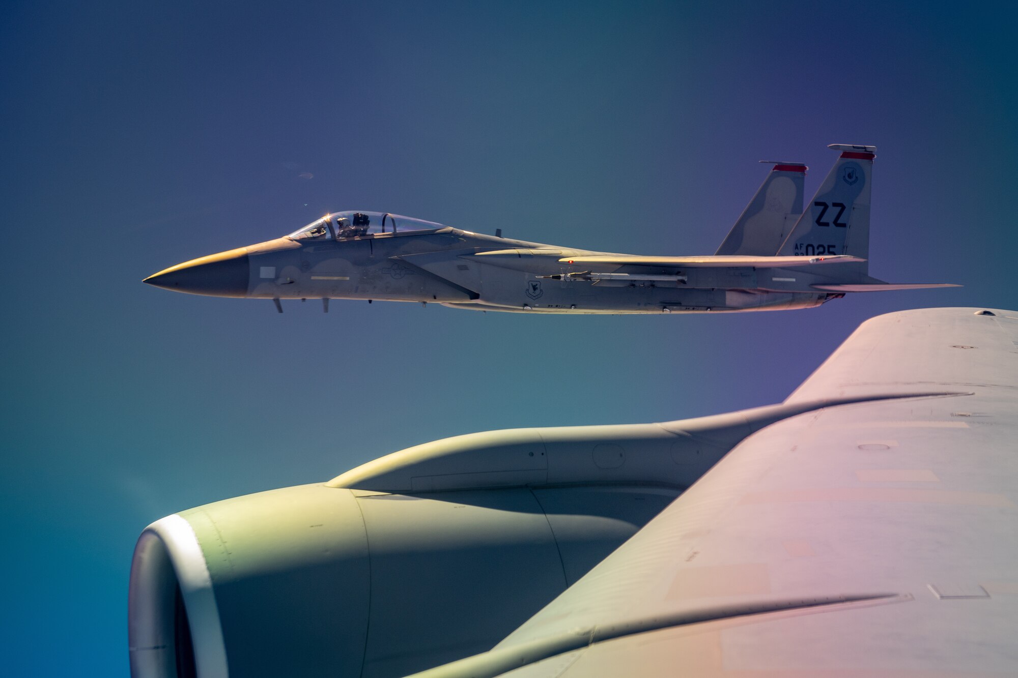 Fighter aircraft flies close to the wing for a KC-135R Stratotanker