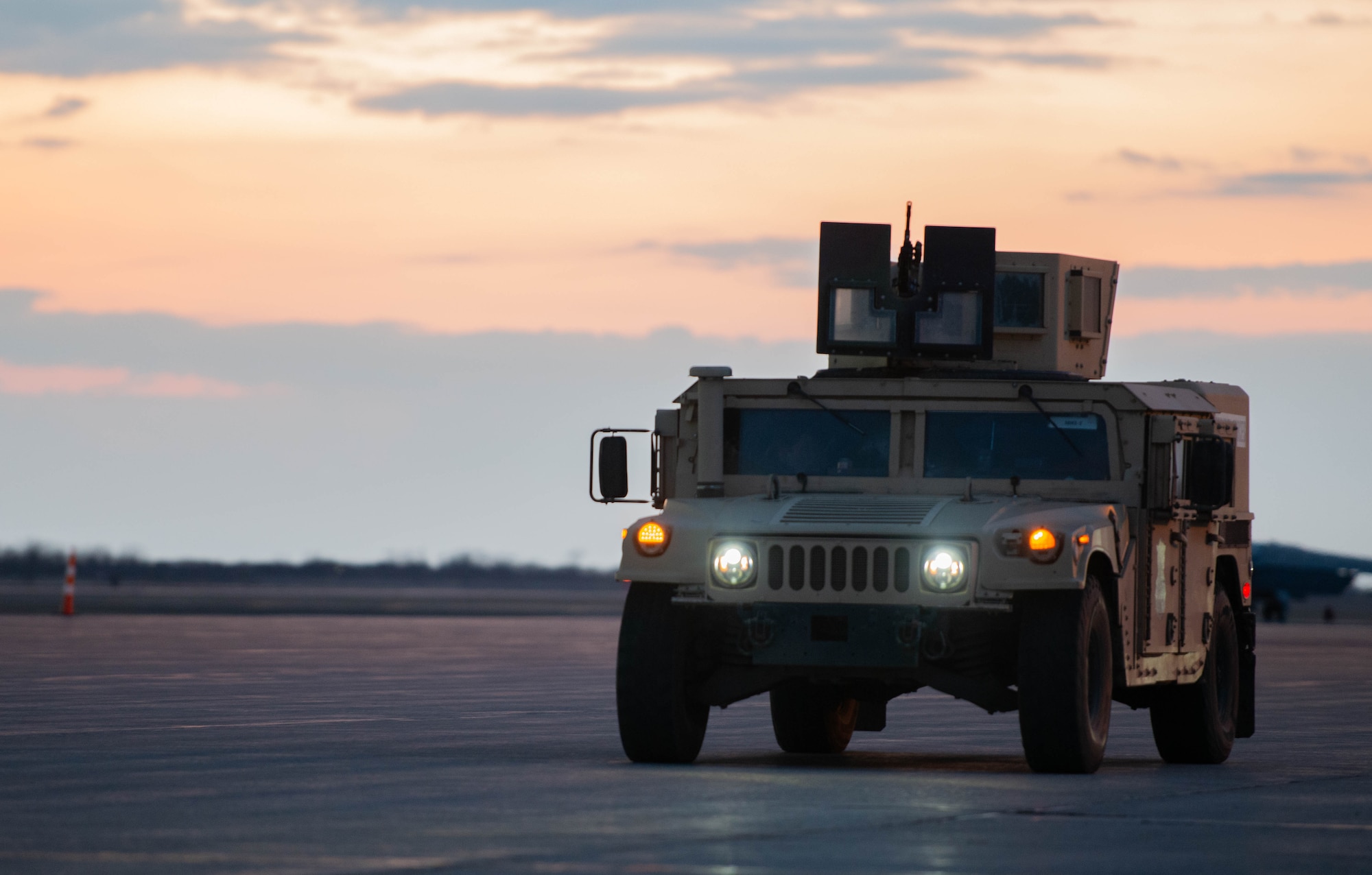 A HUMVEE assigned to the 5th Security Forces Squadron drives down the flightline during Exercise Prairie Vigilance/Bayou Vigilance 24-3 at Minot Air Force Base, North Dakota, April 8, 2024. Minot Air Force Base is committed to its mission of executing nuclear operations and global strike anytime, anywhere, to deter and, if necessary, respond to strategic attack. (U.S. Air Force photo by Airman 1st Class Luis Gomez)