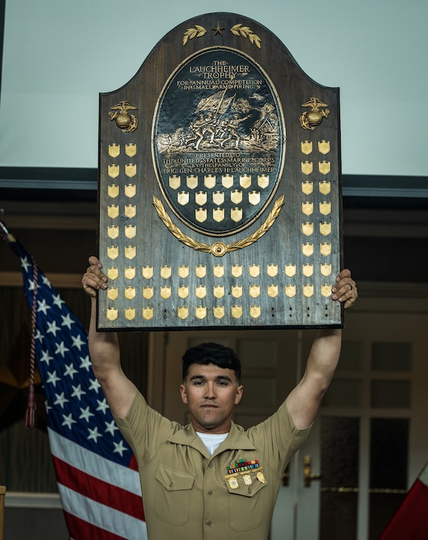 U.S. Marine Corps Staff Sgt. Payton Garcia, with the Marine Corps Shooting Team, receives the Lauchheimer Trophy, established by U.S. Marine Corps General Lauchheimer who captained the first Marine team to enter the rifle competition, during the 2024 Marine Corps Rifle and Pistol Championship Awards Ceremony at The Clubs at Quantico on Marine Corps Base Quantico, Virginia, April 9, 2024. Marines who demonstrate maturity, professionalism, and exceptional marksmanship talent at the Marine Corps Championships will receive an invitation from the team captain of the MCST to serve as a summer augment. Summer augments to the MCST will further compete in state, regional, national, and inter-service matches. (U.S. Marine Corps photo by Lance Cpl. Ethan Miller)