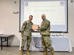 U.S. Air Force Staff Sgt. Colin Kistner is presented with the 174th Attack Wing Diamond Sharp Award by Master Sgt. Robert Hood, first sergeant of the 174th Operations Support Squadron, March 8, 2024, at Hancock Field Air National Guard Base in Syracuse, New York.