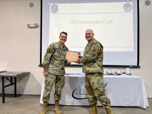 U.S. Air Force Staff Sgt. Colin Kistner is presented with the 174th Attack Wing Diamond Sharp Award by Master Sgt. Robert Hood, first sergeant of the 174th Operations Support Squadron, March 8, 2024, at Hancock Field Air National Guard Base in Syracuse, New York.