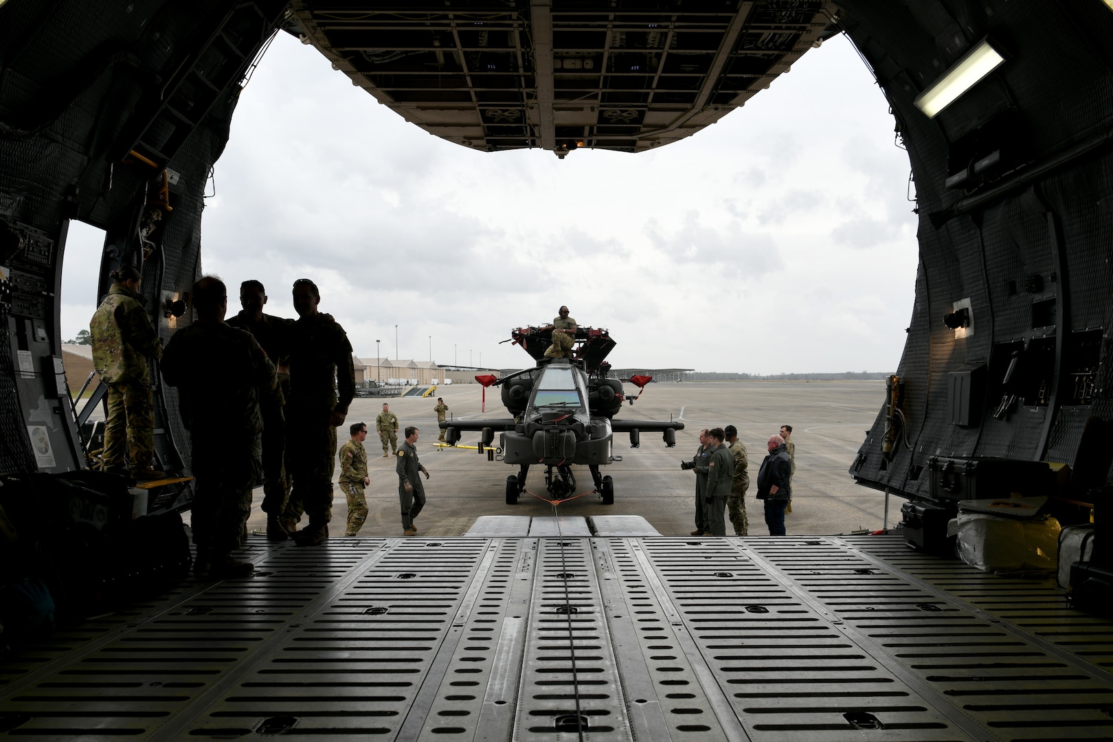 U.S. Airmen assigned to the 20th Logistics Readiness Squadron at Shaw Air Force Base, S.C., and the 337th Airlift Squadron from Westover Air Reserve Base, Mass., and U.S. Soldiers assigned to the 1-151st Attack Reconnaissance Battalion, South Carolina Army National Guard, prepare to load an AH-64E Apache Guardian helicopter onto a C-5M Super Galaxy at Shaw AFB, March 22, 2024.
