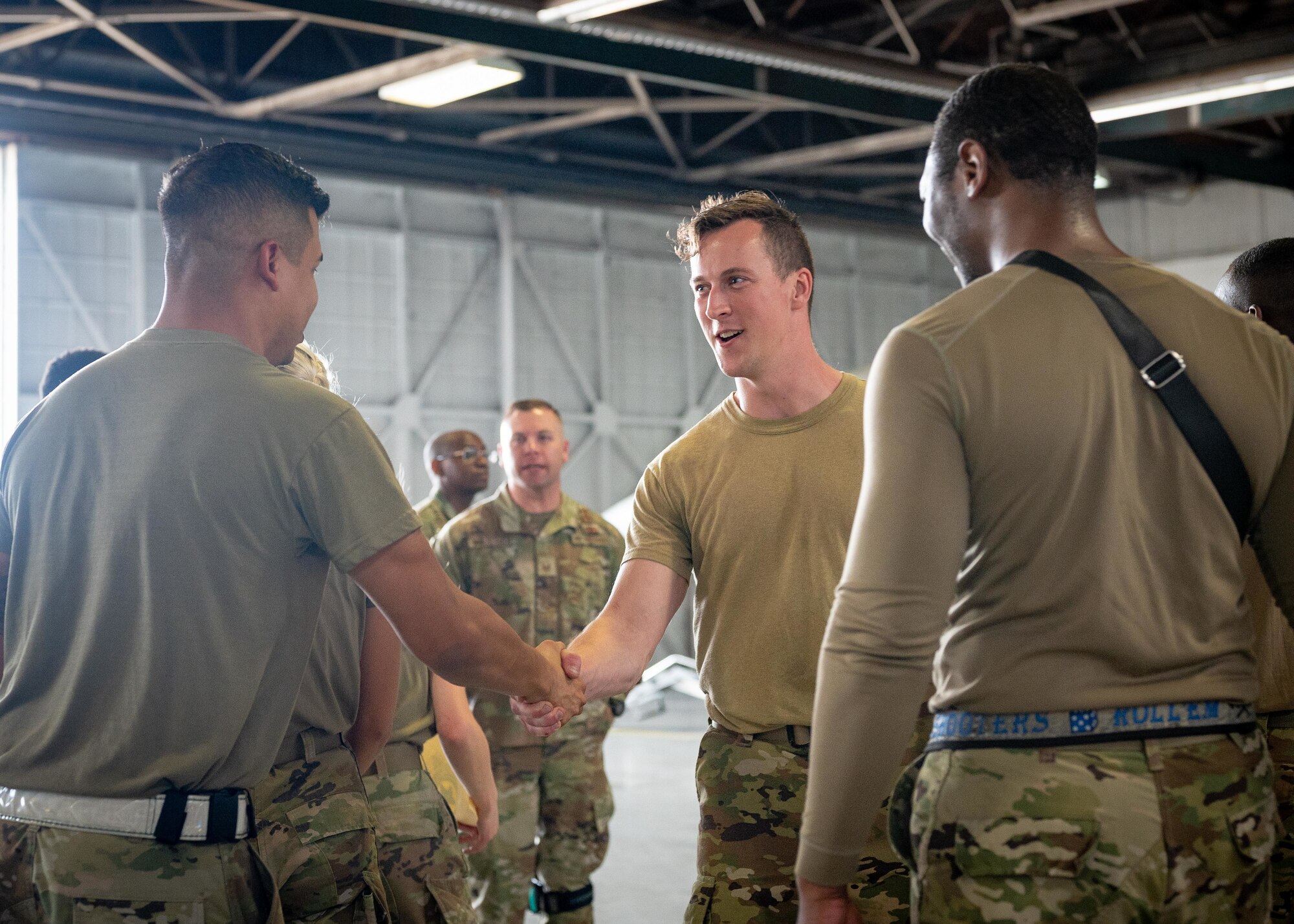 Airmen from the load crews shake hands after the competition.
