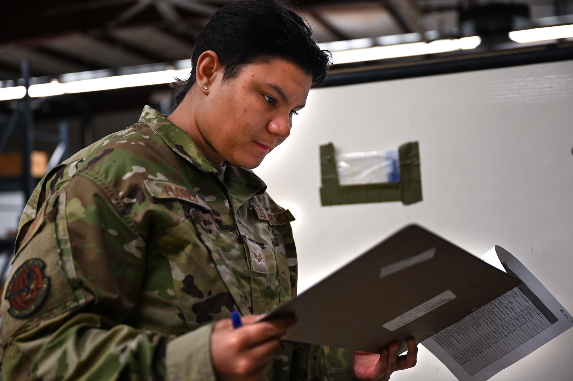 Military member looks into documents.