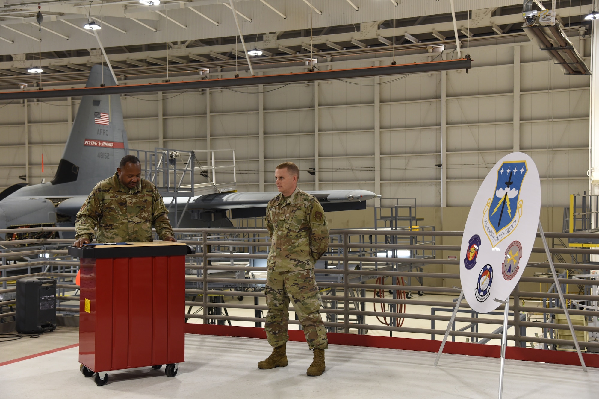 A new staff sergeant stands at parade rest while being sworn in during NCO induction ceremony by a technical sergeant.