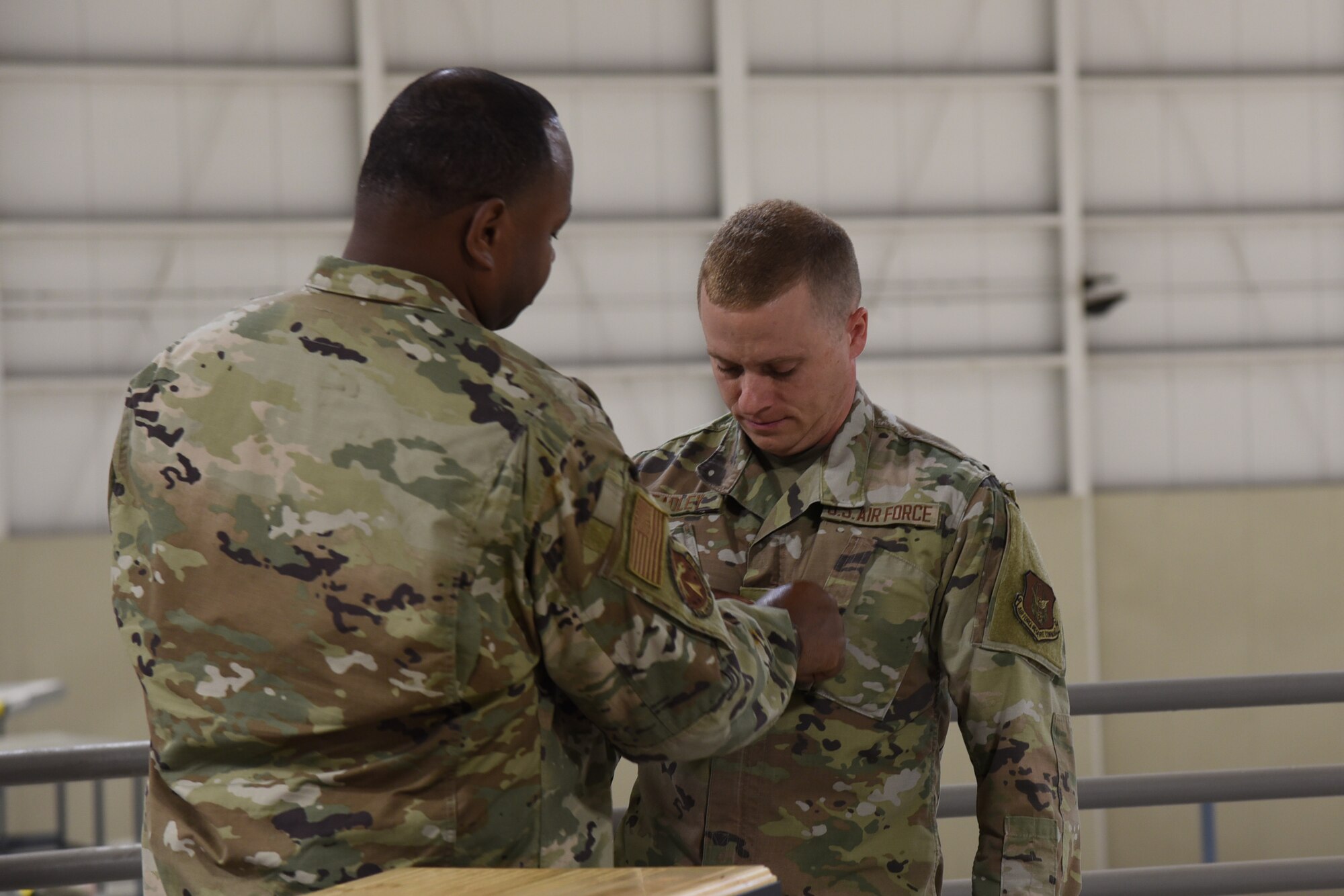 New staff sergeant receives his rank after being sworn in to NCO ranks during induction ceremony.
