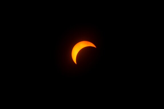 The partial solar eclipse as seen from Joint Base McGuire-Dix-Lakehurst, N.J., April 8, 2024. In New Jersey at the eclipse's peak, coverage was approximately 85 percent of the sun’s surface. (U.S. Air Force photo by Senior Airman Sergio Avalos)