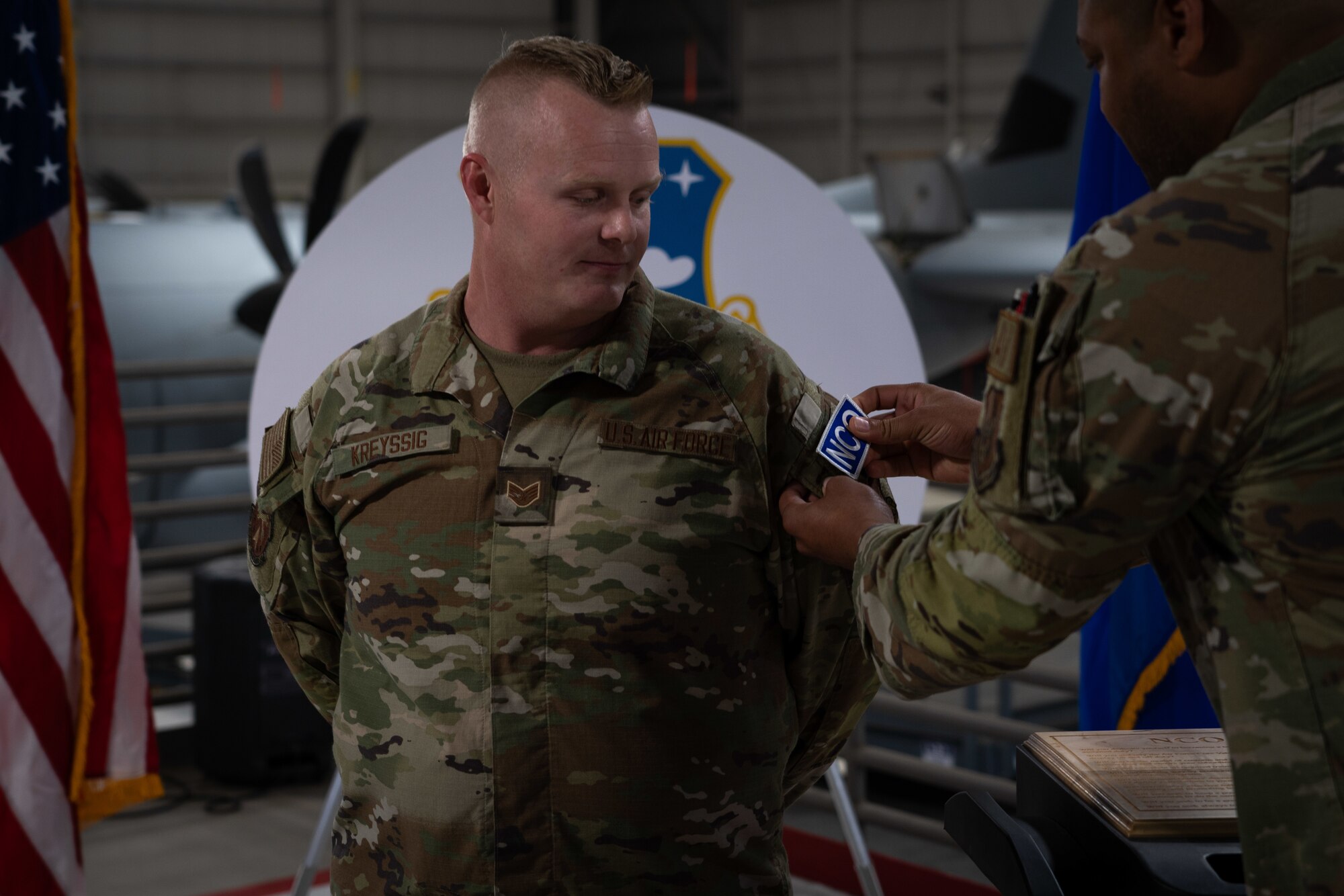 New staff sergeant receives his one day NCO patch after being sworn into the NCO ranks by a master sergeant.