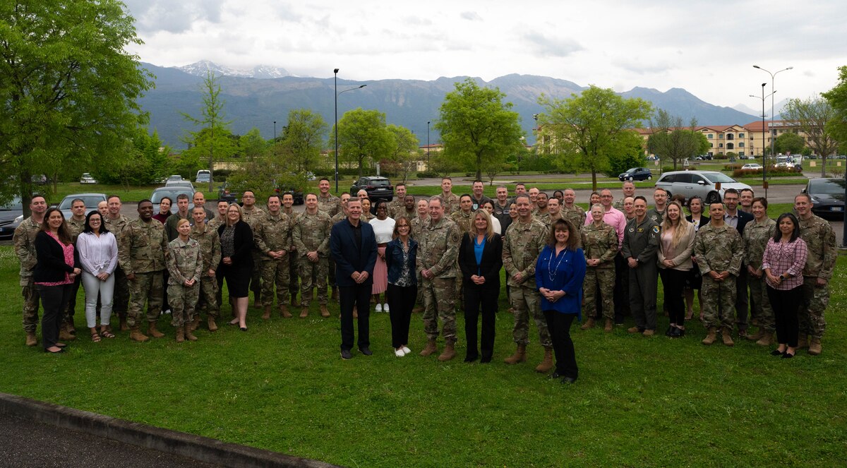 Airman and their spouses pose for a group photo.