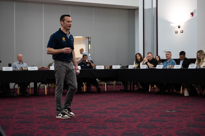 An Airman speaks at a conference.