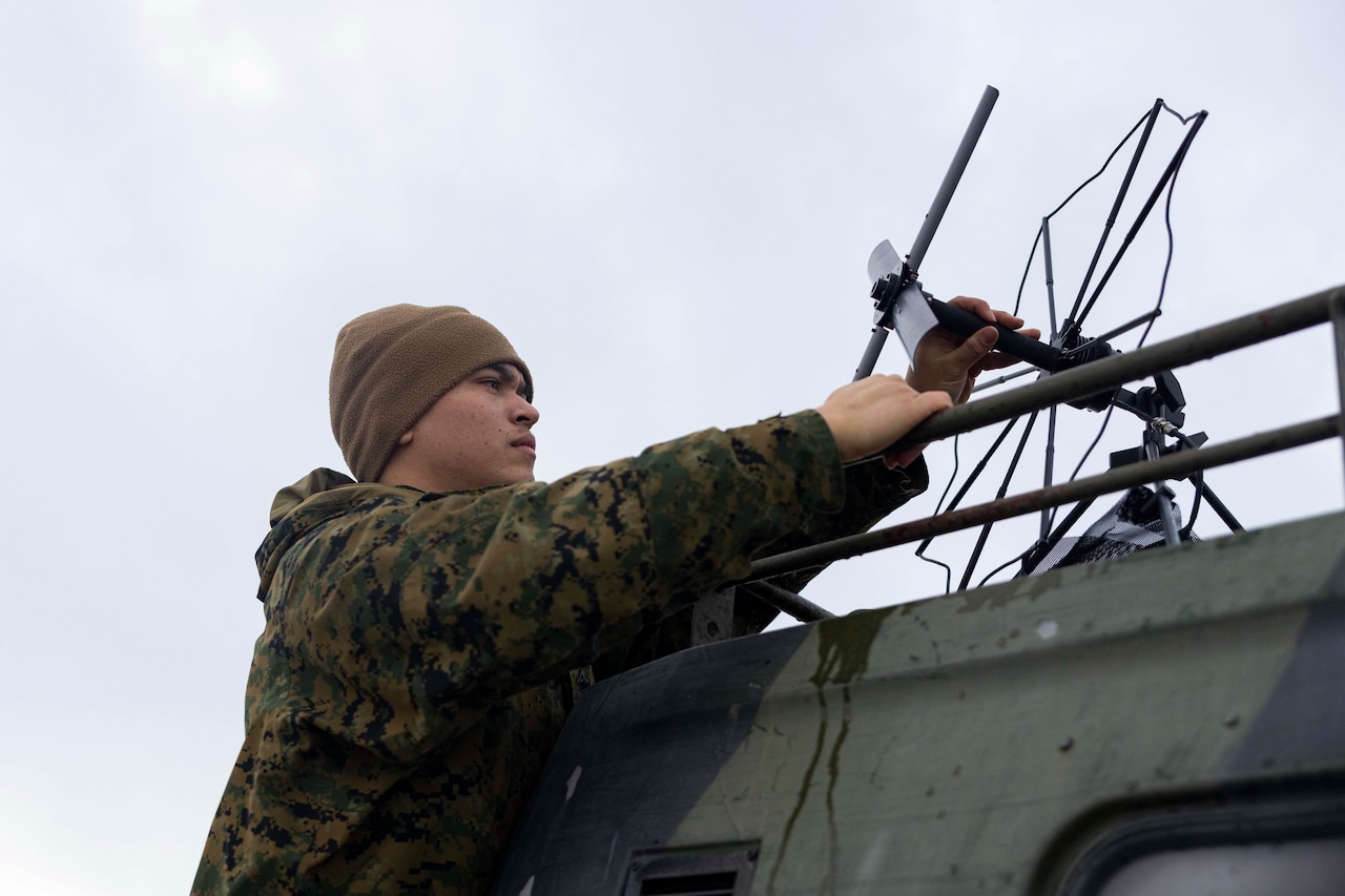 A Marine assembles an antenna.