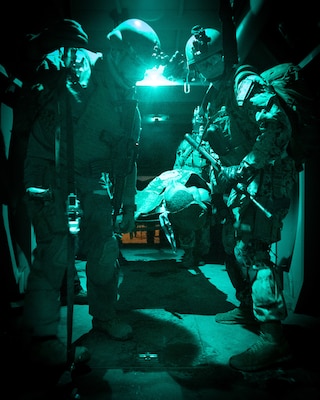 ECRS team Bravo onload a simulated patient at night as part of the initial course implementation of En-route Care System (ECRS) as part of the an Operational Readiness Evaluation (ORE) of Navy Medicine EXMED systems, March 15., ERCS is one of the Navy’s expeditionary medicine capabilities that provides a ready, rapidly deployable and combat effective medical forces to improve survivability across the full spectrum of care, regardless of environment. and revised provides uninterrupted care during patient movement from the point of injury (POI) through Role 4 care without clinically compromising the patients’ condition. The Navy Medicine Operational Training Command (NMOTC) is the Navy’s leader in operational medicine and trains specialty providers for aviation, surface, submarine, expeditionary, and special operations communities. (U.S. Navy photo by Mass Communication Specialist 1st Class Russell Lindsey SW/AW)