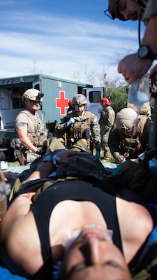 Lt. Rebecca Smith, assigned to ERCS Bravo, gets report on a simulated patient from a point of injury (POI) team consisting of special operations independent duty corpsman (SOIDC) and NEMTI staff as part of the initial course implementation of En-route Care System (ECRS) as part of the Navy's Expeditionary Medicine System (EXMED), March 16. ERCS is one of the Navy’s expeditionary medicine capabilities that provides a ready, rapidly deployable and combat effective medical forces to improve survivability across the full spectrum of care, regardless of environment. and revised provides uninterrupted care during patient movement from the point of injury (POI) through Role 4 care without clinically compromising the patients’ condition. The Navy Medicine Operational Training Command (NMOTC) is the Navy’s leader in operational medicine and trains specialty providers for aviation, surface, submarine, expeditionary, and special operations communities. (U.S. Navy photo by Mass Communication Specialist 1st Class Russell Lindsey SW/AW)