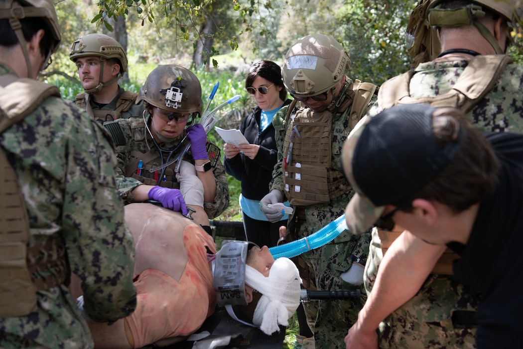 240317-N-BC658-1328 LCDR Michelle Caskey (center left), assigned to Emergency Resuscitative Surgical System (ERSS) Bravo checks vitals on a simulated patient as part of an Operational Readiness Evaluation (ORE) of Navy EXMED capabilities at Naval Expeditionary Medical Training Institute (NEMTI), March 17. ERSS is one of the Navy’s expeditionary medicine capabilities that provides a ready, rapidly deployable and combat effective medical forces to improve survivability across the full spectrum of care, regardless of environment. and provides targeted lifesaving interventions to patients onboard platforms and in austere environments without clinically compromising the patients’ condition. The Navy Medicine Operational Training Command (NMOTC) is the Navy’s leader in operational medicine and trains specialty providers for aviation, surface, submarine, expeditionary, and special operations communities. (U.S. Navy photo by Mass Communication Specialist 1st Class Russell Lindsey SW/AW)