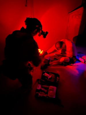 A special operations independent duty corpsman (SOIDC) checks vitals and renders aid to a simulated patient during a night exercise as part of an Operational Readiness Evaluation (ORE) of Navy EXMED capabilities at Naval Expeditionary Medical Training Institute (NEMTI), March 18. SOIDC are trained and qualified Petty Officers who possess the advanced skills and knowledge required to perform duties as a SEAL medic or a Force Reconnaissance Hospital Corpsman. SOIDCs and all POI care and training are one part of the Navy’s expeditionary medicine capabilities that provide a ready, rapidly deployable and combat effective medical force to improve survivability across the full spectrum of care, regardless of environment. and provide targeted lifesaving interventions to patients onboard platforms and in austere environments without clinically compromising the patients’ condition. The Navy Medicine Operational Training Command (NMOTC) is the Navy’s leader in operational medicine and trains specialty providers for aviation, surface, submarine, expeditionary, and special operations communities. (U.S. Navy photo by Mass Communication Specialist 1st Class Russell Lindsey SW/AW)
