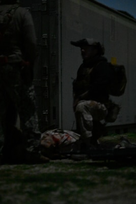 A special operations independent duty corpsman (SOIDC) secures a parameter, renders aid, and radios for evacuation for a simulated patient during a night exercise as part of an Operational Readiness Evaluation (ORE) of Navy EXMED capabilities at Naval Expeditionary Medical Training Institute (NEMTI), March 17. SOIDC are trained and qualified Petty Officers who possess the advanced skills and knowledge required to perform duties as a SEAL medic or a Force Reconnaissance Hospital Corpsman. SOIDCs and all POI care and training are one part of the Navy’s expeditionary medicine capabilities that provide a ready, rapidly deployable and combat effective medical force to improve survivability across the full spectrum of care, regardless of environment. and provide targeted lifesaving interventions to patients onboard platforms and in austere environments without clinically compromising the patients’ condition. The Navy Medicine Operational Training Command (NMOTC) is the Navy’s leader in operational medicine and trains specialty providers for aviation, surface, submarine, expeditionary, and special operations communities. (U.S. Navy photo by Mass Communication Specialist 1st Class Russell Lindsey SW/AW)