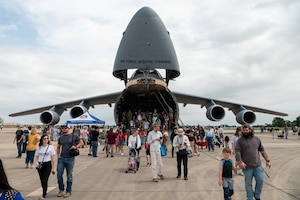 The Great Texas Airshow attendees walk out of the 433rd Airlift Wing’s C-5M Super Galaxy near the entrance of the airshow at Joint Base San Antonio-Randolph, Texas Apr. 7, 2024.