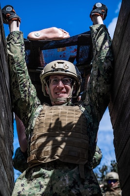 LCDR Conor Hynes, trauma surgeon assigned to Emergency Resuscitative Surgery System (ERSS) Bravo lifts a simulated patient over his head through an obstacle course as part of the initial course implementation of En-route Care System (ERCS), March 14. ERSS is one of the Navy’s expeditionary medicine capabilities that provides a ready, rapidly deployable and combat effective medical forces to improve survivability across the full spectrum of care, regardless of environment. and provides targeted lifesaving interventions to patients onboard platforms and in austere environments without clinically compromising the patients’ condition. The Navy Medicine Operational Training Command (NMOTC) is the Navy’s leader in operational medicine and trains specialty providers for aviation, surface, submarine, expeditionary, and special operations communities. (U.S. Navy photo by Mass Communication Specialist 1st Class Russell Lindsey SW/AW)