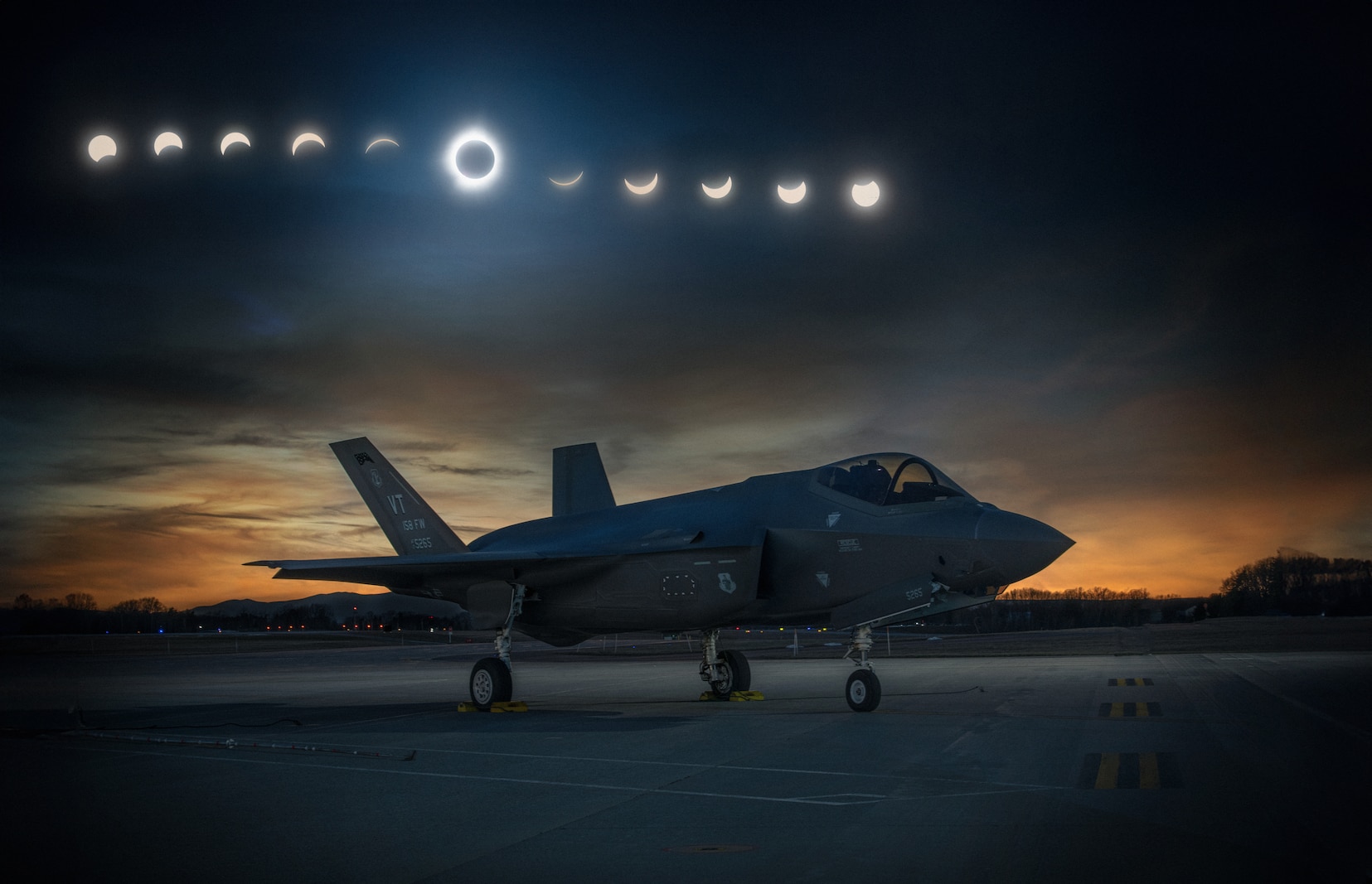 Photo of an F-35A Lightning II assigned to the Vermont Air National Guard's 158th Fighter Wing sitting on the flight line during the 2024 total solar eclipse, South Burlington Air National Guard Base, Vermont, April 8, 2024.