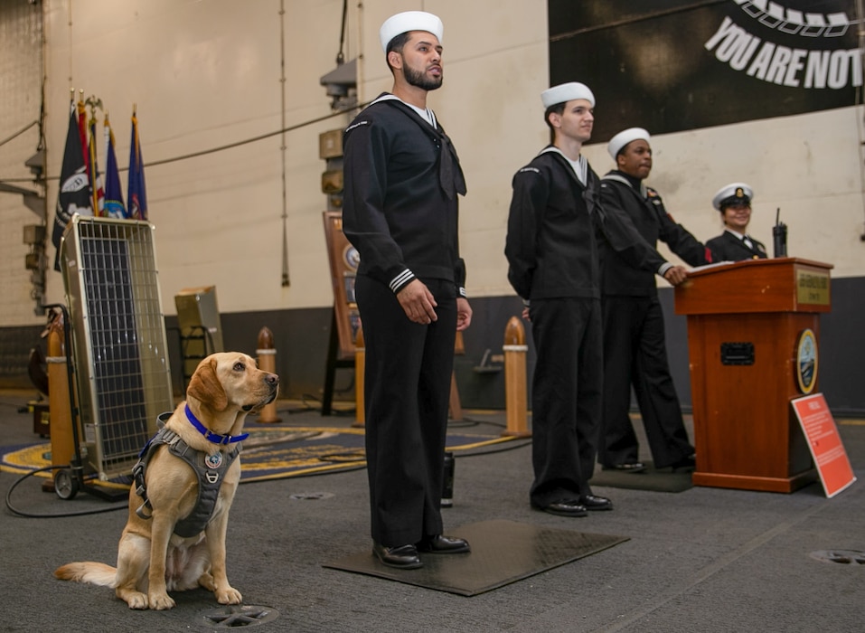 Capt. Sage sits next to watchstanders on the quarterdeck aboard USS Gerald R. Ford (CVN 78).