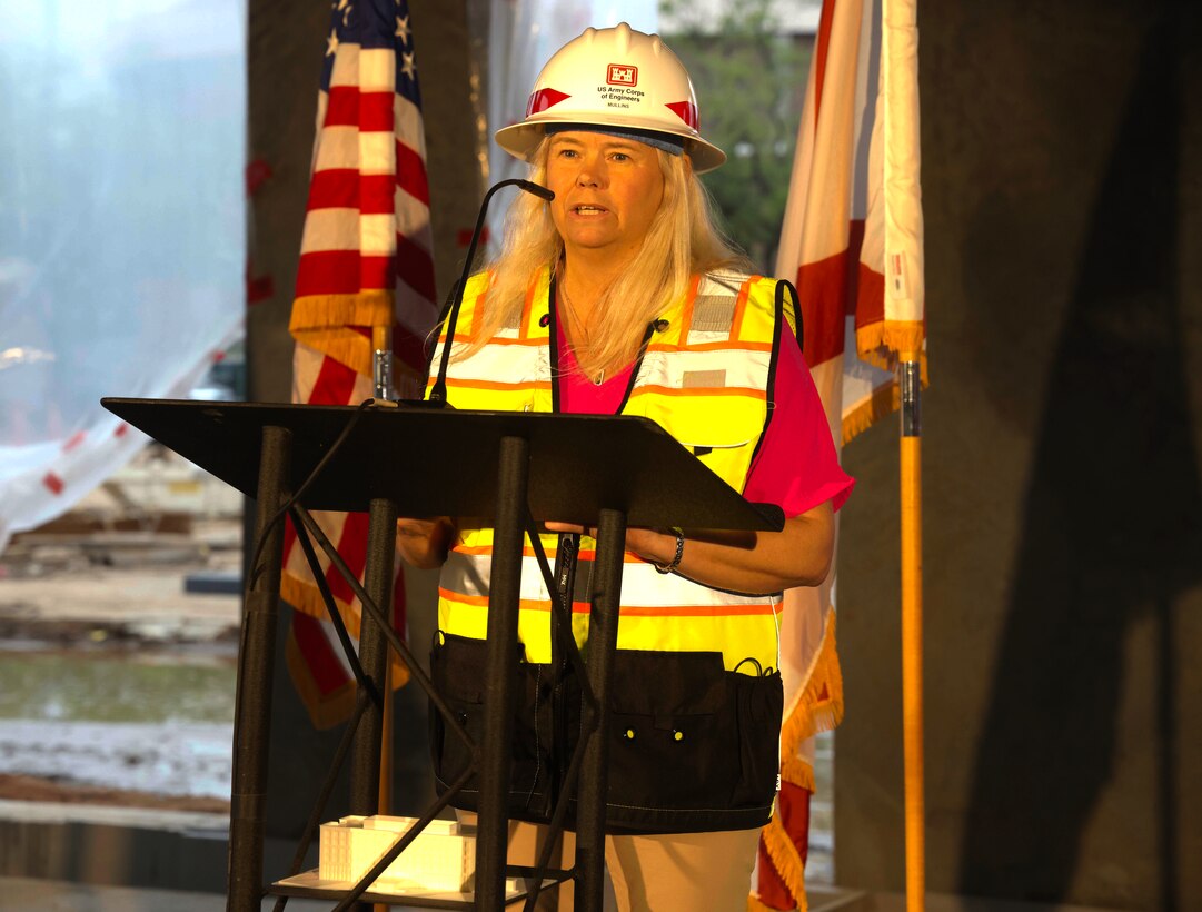 Woman speaking at podium.