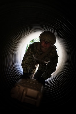 LCDR Michelle Caskey, assigned to Emergency Resuscitative Surgical System (ERSS) Bravo crawls through an obstacle course carrying simulated fuel and other gear as part of an Operational Readiness Evaluation (ORE) of Navy EXMED capabilities at Naval Expeditionary Medical Training Institute (NEMTI), March 14. NEMTI staff teach the importance of a walking blood bank in the curriculum of all of Navy EXMED systems which allows anyone to be called upon to donate blood to those wounded in an austere and contested environment and allows for maximum survivability of the warfighter. ERSS is one of the Navy’s expeditionary medicine capabilities that provides a ready, rapidly deployable and combat effective medical forces to improve survivability across the full spectrum of care, regardless of environment. and provides targeted lifesaving interventions to patients onboard platforms and in austere environments without clinically compromising the patients’ condition. The Navy Medicine Operational Training Command (NMOTC) is the Navy’s leader in operational medicine and trains specialty providers for aviation, surface, submarine, expeditionary, and special operations communities. (U.S. Navy photo by Mass Communication Specialist 1st Class Russell Lindsey SW/AW)