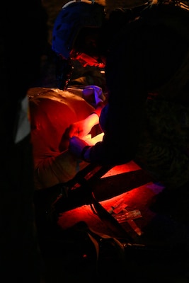 A special operations independent duty corpsman (SOIDC) checks vitals and renders aid to a simulated patient during a night exercise as part of an Operational Readiness Evaluation (ORE) of Navy EXMED capabilities at Naval Expeditionary Medical Training Institute (NEMTI), March 18. SOIDC are trained and qualified Petty Officers who possess the advanced skills and knowledge required to perform duties as a SEAL medic or a Force Reconnaissance Hospital Corpsman. SOIDCs and all POI care and training are one part of the Navy’s expeditionary medicine capabilities that provide a ready, rapidly deployable and combat effective medical force to improve survivability across the full spectrum of care, regardless of environment. and provide targeted lifesaving interventions to patients onboard platforms and in austere environments without clinically compromising the patients’ condition. The Navy Medicine Operational Training Command (NMOTC) is the Navy’s leader in operational medicine and trains specialty providers for aviation, surface, submarine, expeditionary, and special operations communities. (U.S. Navy photo by Mass Communication Specialist 1st Class Russell Lindsey SW/AW)